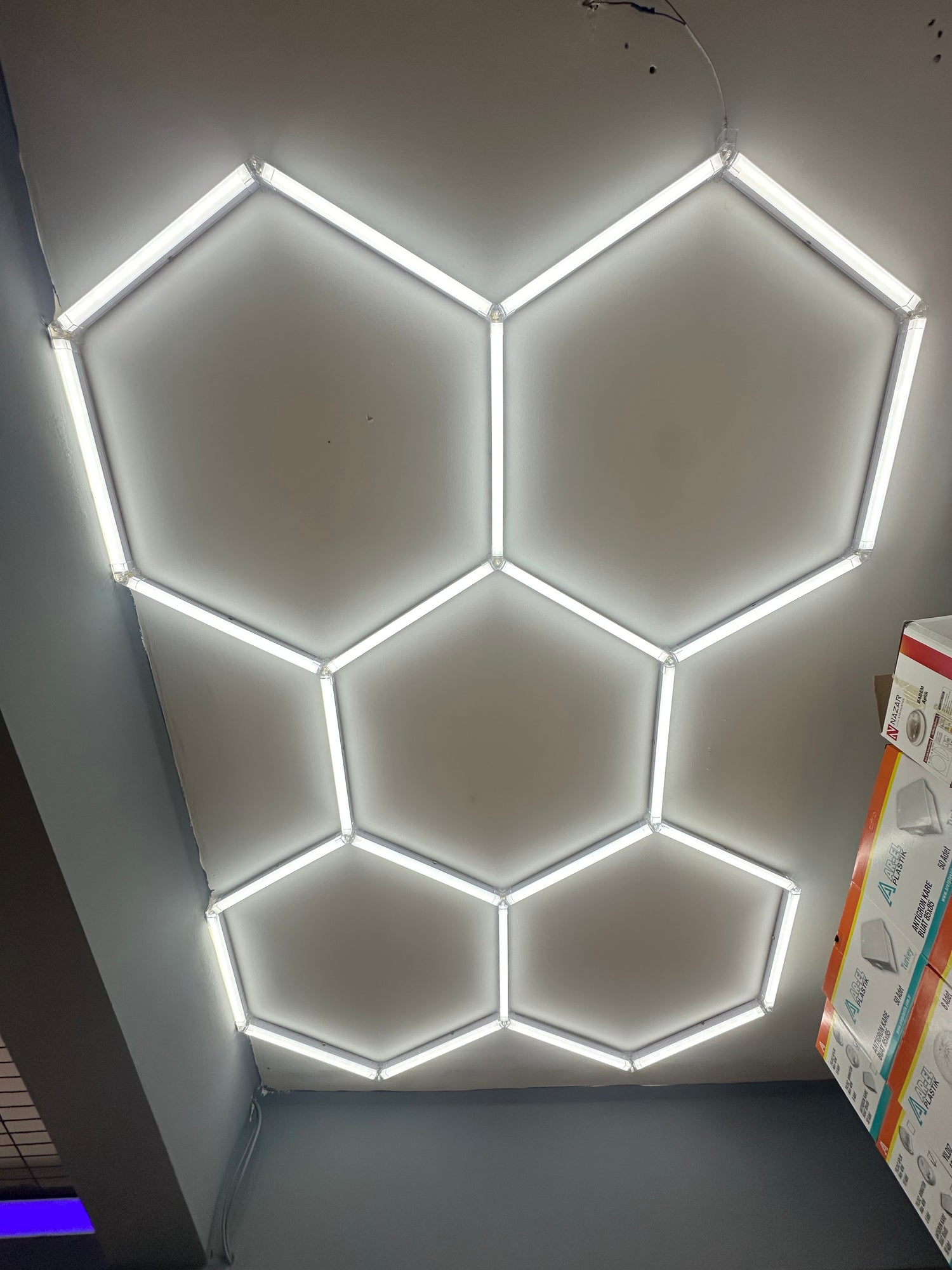 Cata Petek Aydınlatma by Enerji Aydınlatma featuring sleek modern design and warm lighting, mounted on a wall.